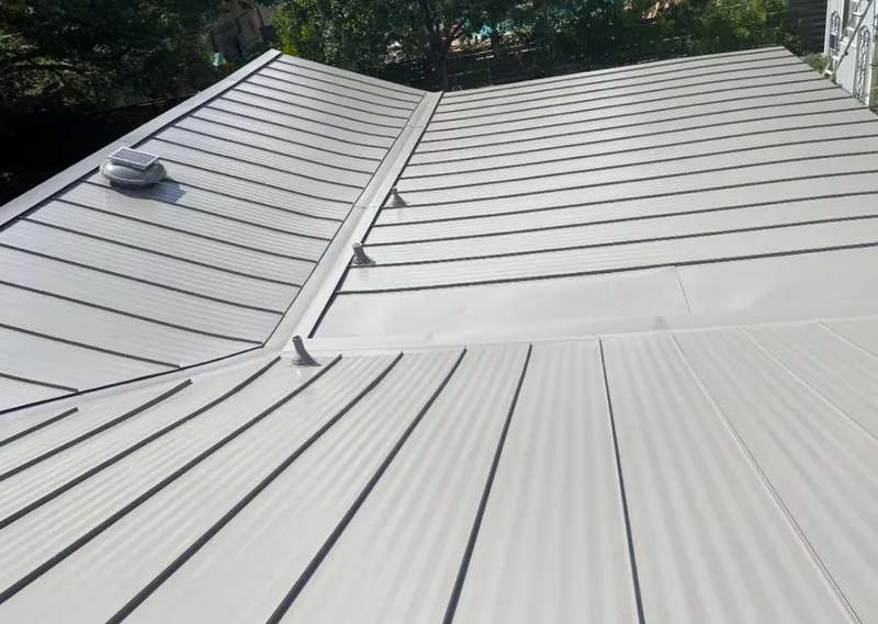 Solar attic fan installed on a metal roof for Roof Ventilation in Jasper